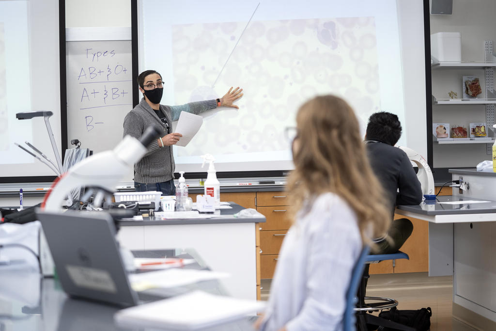 Mason professor teaching in a mask during COVID pandemic